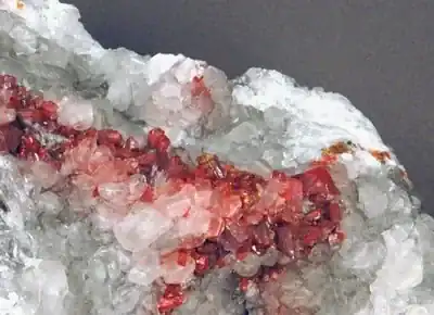 Realgar & pararealgar & calcite on marble (Getchell Mine, Nevada)